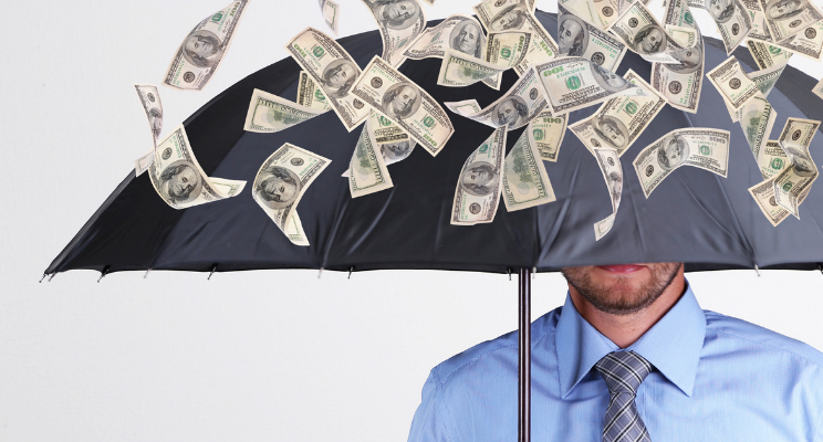cash flowing down on man with umbrella